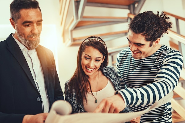 estate agent is showing house couple buyers telling clients about home advantages interior designer is discussing renovation ideas with homeowners 360066 9413