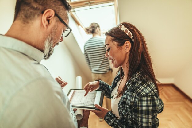 estate agent is showing house couple buyers telling clients about home advantages interior designer is discussing renovation ideas with homeowners 360066 9460