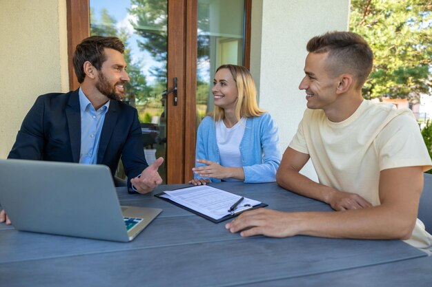 real estate agent discussing deal details with clients 259150 86025